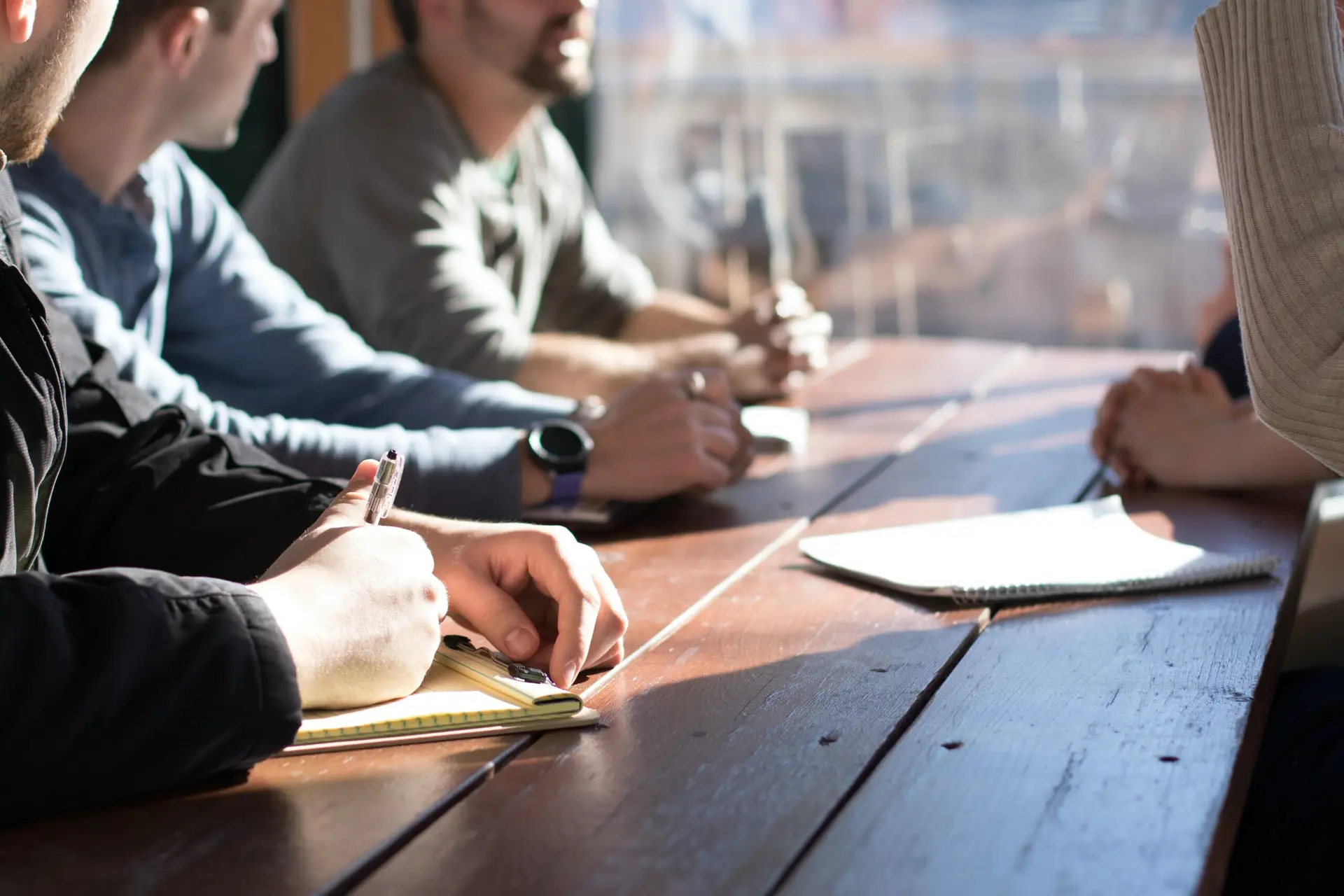 Image of a group of people at a table, learning and training