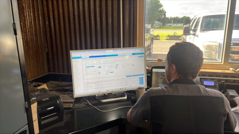 counter employee at rental business using integrarental's equipment rental software